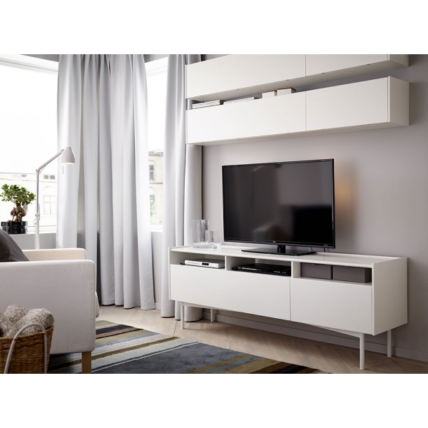 A living room with wall cabinets and a TV bench, all in white
